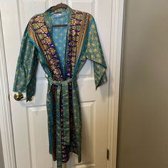 Woman’s Size Medium-Large Cotton Bathrobe. This Robe Is Brand New With Gorgeous Teal, Blues, And Brown Colors. Blue Long Sleeve Sleepwear For Vacation, Blue Bohemian Sleepwear For Home, Blue Bohemian Long Sleeve Sleepwear, Multicolor Cotton Robe For Loungewear, Multicolor Long Cotton Robe, Long Blue Robe For Home, Blue Cotton Robe For Home, Blue Cotton Robe For Relaxation, Multicolor Cotton Robe With Floral Print