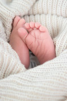 a close up of a baby's foot in a blanket