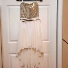 Gold Sequence Stretchy Bustier And Chiffon Flare Dress, Gold Belt Accessory. Fits A Small / Medium Junior, Runs Small For A Medium. White Sleeveless Chiffon Party Dress, White Sleeveless Chiffon Dress For Party, Chiffon Mini Dress For Party And Prom Season, Chiffon Mini Dress For Prom Season Party, Chiffon Mini Dress For Party Season Night Out, Sequin Chiffon Dresses For Prom Season, Chiffon Sequin Dress For Prom Season, White Fitted Chiffon Party Dress, Flowy Dresses For Prom Season