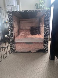 a dog bed in the shape of a cage with a pillow on top of it