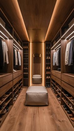 a walk in closet with lots of shoes and clothes on the shelves next to it