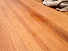 a close up of a wooden table with stains on it