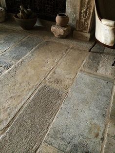 a stone floor in front of a fireplace