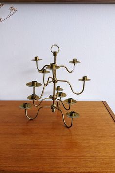 a brass candelabra on a wooden table