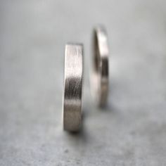 A simple matching wedding band set made up of a 4mm x 1mm and a 2mm x 1mm flat band hand forged from 100% recycled 14k palladium white gold and given a brushed finish. Palladium white gold contains no nickel and is a less brittle alloy than nickel white gold and has no need to be rhodium plated and has a soft grayish/yellowish color . These rings are made to order in any size 4 - 12 (including half sizes) and will be made especially for you and shipped out within 5 weeks, please leave your sizes White Gold Wedding Ring Set, Gold Wedding Ring Set, Mens White Gold Rings, Groom Ring, White Gold Wedding Ring, Mens Gold Wedding Band, Platinum Wedding Rings, Gold Wedding Ring