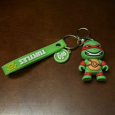 a keychain with a teenage mutant on it and a turtle key chain attached to it