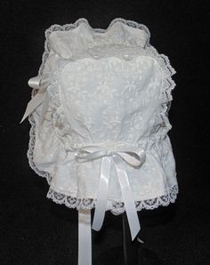 A beautiful Victorian style baby or doll bonnet. Fabric is white cotton raised embroidery. Lining is white . Bonnet has an extended back and is trimmed with white lace. Bows and extra long ties are made of white double sided satin ribbon. Size/ Measurement from under ear lobe around top of head to under other ear lobe 0-3 months / 11 inches 3-6 months / 12 inches 6-9 months / 13 inches 9-12 months / 14 inches 12-18 months / 15 inches 18-24 months / 16 inches Fitted White Bonnet With Lace Trim, Fitted White Bonnet For Baptism, White Fitted Bonnet For Baptism, White Cotton Bonnet For Baptism, White Fitted Vintage Bonnet, White Bonnet, Doll Hats, Raised Embroidery, Doll Hat