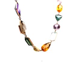 This exquisite modern necklace is crafted from 14 karat yellow gold, creating a luxurious and elegant piece that is sure to spark a conversation. The long piece features a series of multi-gemstone bezel set stones, with a total of 91.52 carats of citrine, 89.96 carats of aquamarine, 80.66 carats of quartz, 79.55 carats of amethyst, 41.31 carats of tourmaline, and 10.20 carats of topaz. The perfect combination of modern design and luxurious gemstones, this necklace is sure to delight the wearer f Luxury Multicolor Briolette Necklaces, Luxury Multicolor Briolette Necklace, Elegant Multicolor Gemstones In Bezel Setting, Elegant Multicolor Gemstones With Bezel Setting, Multicolor Necklaces With Gemstone Accents For Formal Occasions, Modern Multicolored Multi-stone Gemstones, Formal Multicolor Gemstone Necklaces, Elegant Multi-stone Gemstones In 14k Gold, Yellow Gold Briolette Gemstones For Formal Occasions