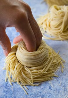 someone is making homemade ramen noodles on a blue surface with the words fresh homemade ramen noodles