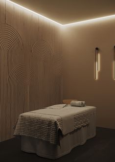 a bed in a room with two lights on the wall