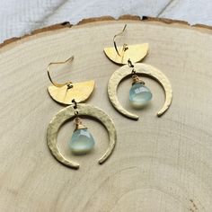 These crescent moon green chalcedony earrings are the perfect unique birthday gift for a daughter! These gold tones brass western earrings would also make a great sweet 16 gift!  This is a pair of lovely geometric brass earrings that I made using brass components, Chalcedony, brass jump rings, and brass ear wires. I have carefully hammered all brass components to create a unique and elegant texture.  This pair of earrings would go great with any casual or formal attire. This is the pair of statement earrings you've been waiting for! Ear wires are lead and nickel free.  All orders ship the next business day.  ......... Back to the shop: www.etsy.com/shop/samesunsetdesign Follow Me:  * IG: @samesunsetdesign * FB: https://www.facebook.com/samesunsetdesign Thank you so much for visiting my sho Handmade Chalcedony Earrings As Gift, Handmade Chalcedony Earrings For Gifts, Brass Hoop Earrings With Moon Charm As A Gift, Unique Moon Charm Earrings As Gift, Teardrop Moon Charm Earrings Gift, Brass Teardrop Earrings With Moon Charm, Teardrop Brass Earrings With Moon Charm, Gold Chalcedony Dangle Earrings, Bohemian Half Moon Earrings For Gifts