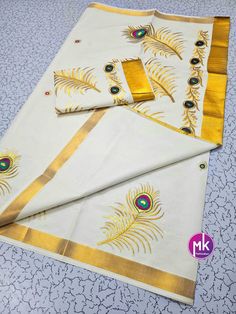 Traditional Kerala Kasavu cotton Saree peacock feather design - Puja kerala Saree with gold border - Stylish cotton Saree for all seasons Fabric  Saree : Cotton with embroidered Blouse: Running Blouse Color     : Saree - White                  Blouse - White (Running blouse) Washing instructions : Dry wash only. Note :  10% Colors may vary slightly due to lighting. If you are interested in purchasing this item and have any questions about this item, please feel free to send us a message. SHIPPIN Saree White, Peacock Feather Design, Kasavu Saree, Saree Cotton, Kerala Saree, White Saree, Jewelry Care Instructions, Gold Border, Feather Design