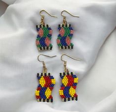 Add a vibrant pop of color and geometric flair to your look with these beaded earrings! Handmade with meticulous attention to detail, each pair features a unique wavy pattern crafted from an array of colorful beads.  Highlights:  * Handmade with high-quality beads  * Eye-catching wavy pattern  * Vibrant color combinations  * Lightweight and comfortable to wear   Perfect for:  * Adding a playful touch to your everyday  Outfits  * Elevating your  attire  * Gifting to the fashion-forward friend in Festive Multicolor Beaded Dangling Earrings, Multicolor Large Beaded Round Earrings, Handmade Multicolor Beaded Earrings For Festive Occasion, Wavy Pattern, Earrings Handmade, Everyday Outfits, Beaded Earrings, Color Combinations, Jewelry Earrings Dangle