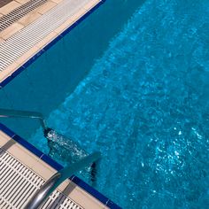 an overhead view of a swimming pool with blue water