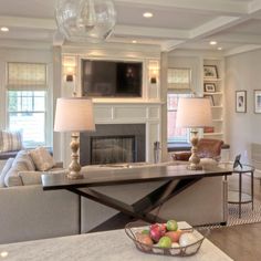 a living room filled with furniture and a flat screen tv mounted to the wall above a fireplace