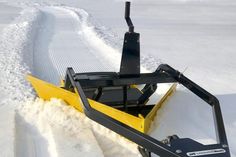 a snow plow is parked on the side of a road in the snow with it's front end partially covered by snow