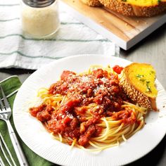 a plate with spaghetti and bread on it