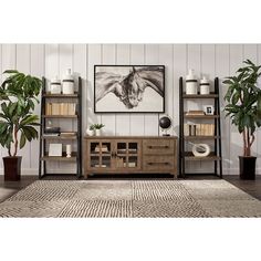 a living room filled with furniture next to a painting and potted plants on top of a rug