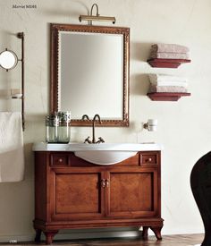 a bathroom vanity with a mirror above it