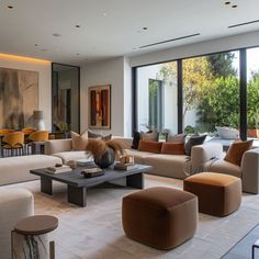 a living room filled with lots of furniture and large glass doors leading to an outside patio