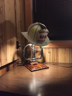 a white hard hat sitting on top of a wooden table