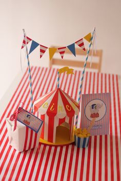 a circus themed birthday party with red and white striped tablecloth