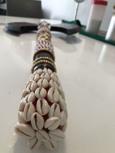 a close up of a beaded object on a table