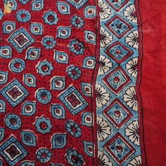 Fabric: Gajji Silk Weave – Bandhani with Ajrakh Pallu Color –Blue & Red Blouse – Ajrakh Note- There may be slight color variations due to photographic reasons. This is a hand-woven product and any irregularities in the weaving or pattern should not be taken as a defect. These irregularities make every handloom piece unique. Bohemian Traditional Wear With Bandhani Print, Red Bandhani Print Traditional Wear For Festival, Red Traditional Wear With Bandhani Print For Festivals, Red Bandhani Traditional Wear For Festival, Bohemian Block Print Traditional Wear For Navratri, Traditional Batik Print Dupatta For Navratri, Traditional Batik Print Dupatta For Festival, Bohemian Block Print Traditional Wear, Red Festival Saree With Motifs