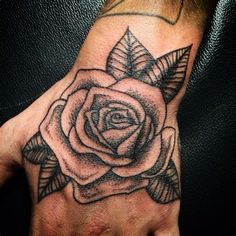 a hand with a rose tattoo on it