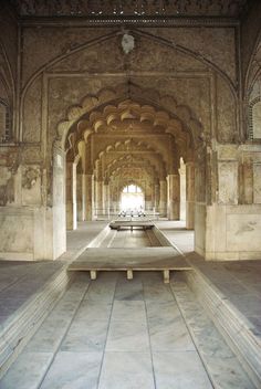 the inside of an old building with benches and arches on it's sides,