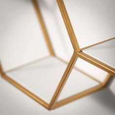 a close up view of an object made out of wood and white glass, with the light reflecting off it's sides