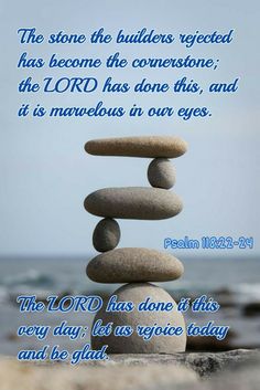 rocks stacked on top of each other in front of the ocean with a bible verse