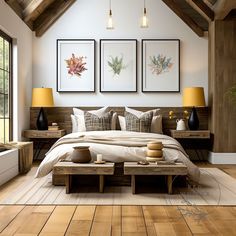 a bedroom with wood flooring and white walls has three framed pictures on the wall