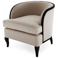 a beige chair with black trim around the arms