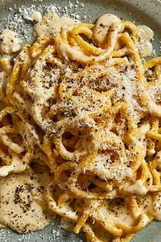 a plate full of pasta covered in sauce and parmesan sprinkles