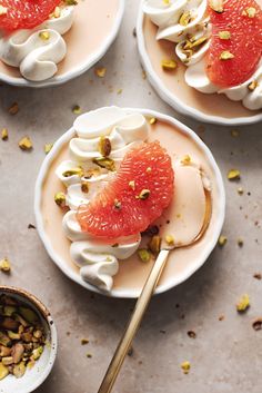 three plates with desserts on them, one has grapefruit and the other has pistachio