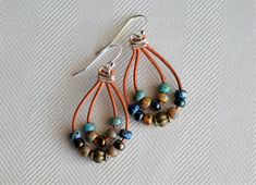 Multi Color Picasso Dangling Earrings. These Earrings are made with picasso miyuki beads and metal beads on light brown natural distressed leather cord, they are approximately 2'' long and hooks are silver plated.  The Earrings are stunning, something that will catch lots of compliments. They are lightweight, will compliment your look. The Earrings will make priceless addition to your handmade jewelry collection. Great gift for someone special as well! Please contact me if you have any questions Bohemian Dangle Wrap Earrings, Bohemian Dangle Wrap Earrings For Pierced Ears, Bohemian Adjustable Teardrop Earrings, Bohemian Adjustable Nickel-free Wrap Earrings, Bohemian Teardrop Wrap Earrings, Adjustable Teardrop Bohemian Wrap Earrings, Bohemian Wrap Dangle Earrings With Ear Wire, Bohemian Wrap Earrings With Ear Wire, Multicolor Teardrop Hoop Earrings Bohemian Style