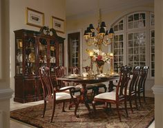 a dining room table with chairs and a chandelier