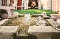 a water fountain in front of a house