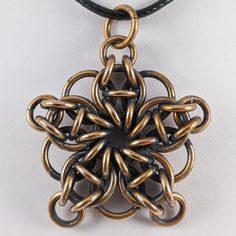 Oxidized Bronze Celtic Star Pendant This is a are hand crafted pendant made of jewelers bronze. The piece has been oxidized and then hand polished to bring out the contrast and give it a classic antiqued look. The chainmaille jewelry designs are 100% hand made. The jump rings are hand wrapped and Handmade Medieval Bronze Jewelry, Medieval Handmade Bronze Jewelry, Medieval Style Handmade Bronze Jewelry, Metal Jewelry With Jump Ring For Crafting, Handmade Medieval Brass Necklaces, Handmade Medieval Brass Necklace, Metal Jump Ring Jewelry For Diy, Gold Steampunk Jewelry Made Of Copper, Gold Steampunk Jewelry With Copper