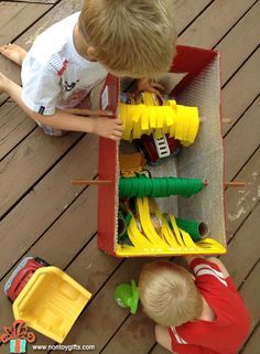 two young boys playing with toys on a deck