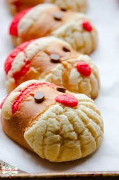 cookies with red and white icing are lined up on a baking sheet