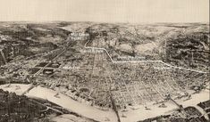 an old black and white photo of a city with lots of buildings, roads, and streets