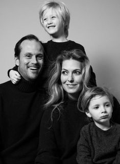 a black and white photo of a family