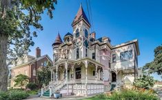 an old victorian style house with many windows and balconies