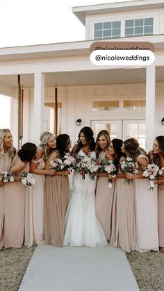 a group of women standing next to each other in front of a white building holding bouquets