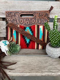 Amazing saddle blanket purse with side fringe detail. Tooled leather top with cradle handle. Zipper top closure. Fully lined inside with side zipper privacy pocket and two pockets open side pockets. All purses come with detachable/optional tooled crossbody strap. Measures: H13 x W15 x D2