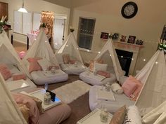 a living room filled with lots of pillows and teepee tentes on the floor