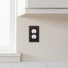 two black and white electrical outlets on the wall