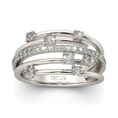 an 18k white gold ring set with three rows of diamonds on each band and the word